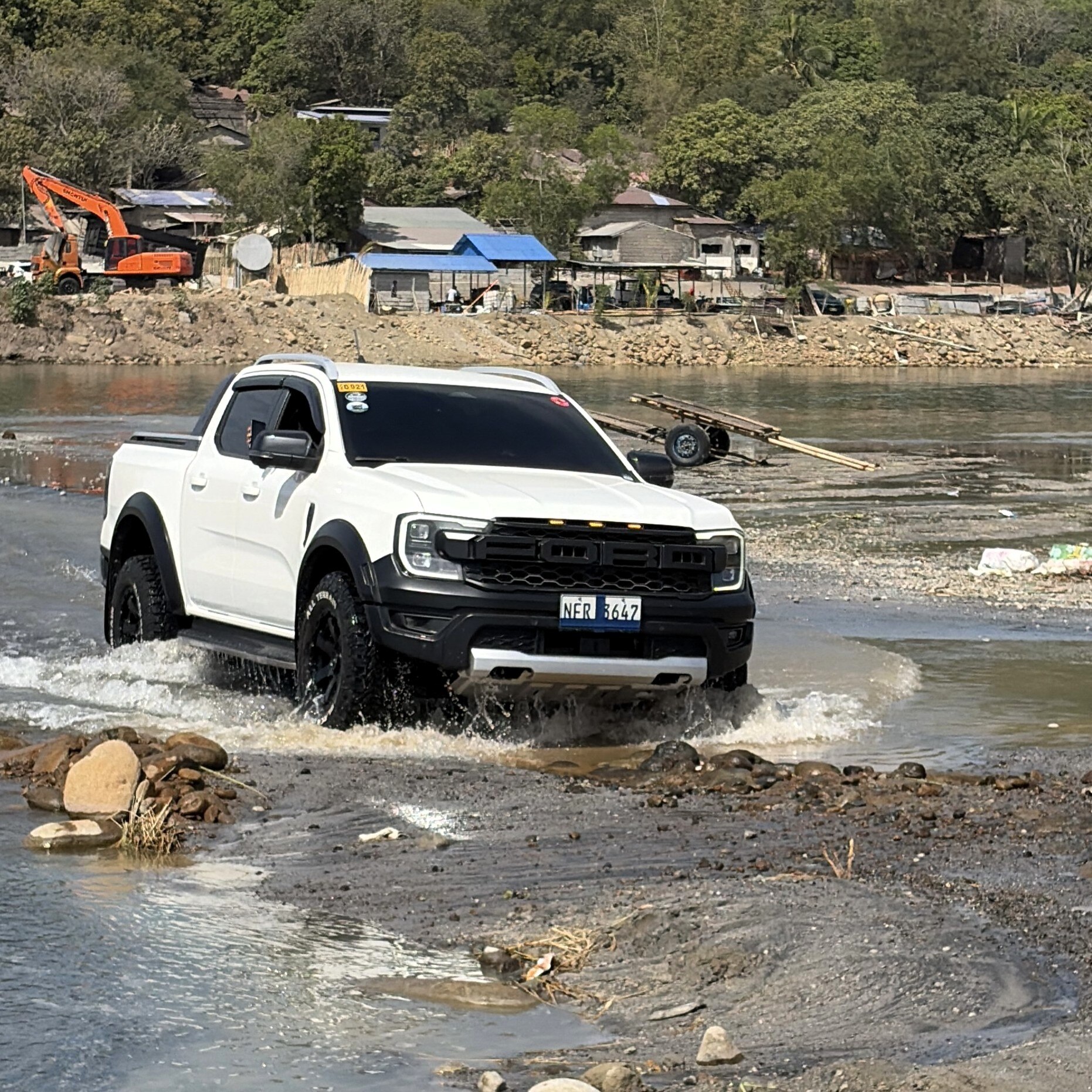 A Ford Ranger going through one of the river crossings in the Botolan-Capas Trail